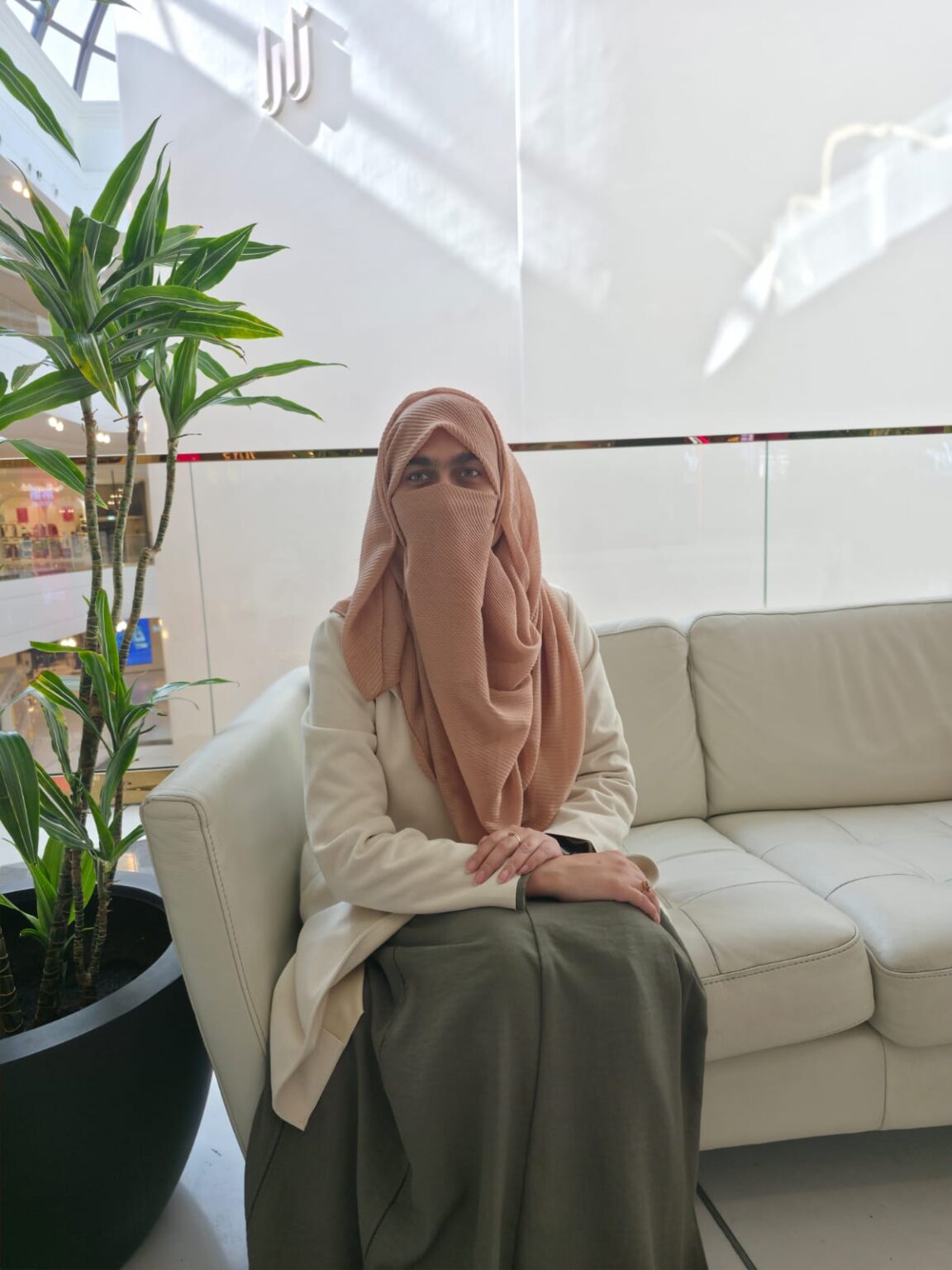 Rahma seated in a calm coaching space